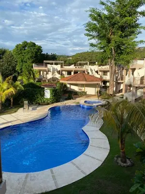 a swimming pool in front of a resort at Sunscape Second Floor Condo with Rooftop in Coco