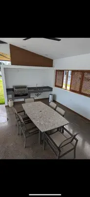 a table and chairs in a room with a stove at 2BR with ocean view in Jacó