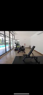 a gym with two exercise bikes in a room at 2BR with ocean view in Jacó