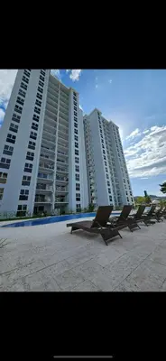 a row of chairs in front of a large building at 2BR with ocean view in Jacó