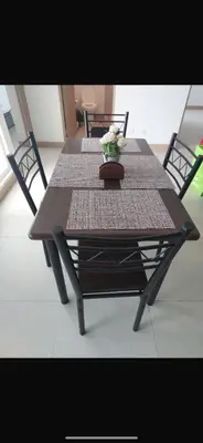 a wooden table with a vase of flowers on it at 2BR with ocean view in Jacó