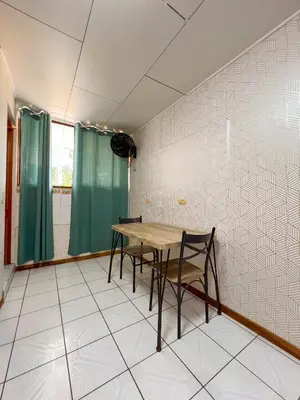 a dining room with a wooden table and chairs at Casa Guarumo in Manuel Antonio
