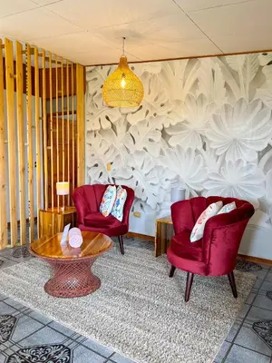 a living room with two chairs and a table at Casa Guarumo in Manuel Antonio