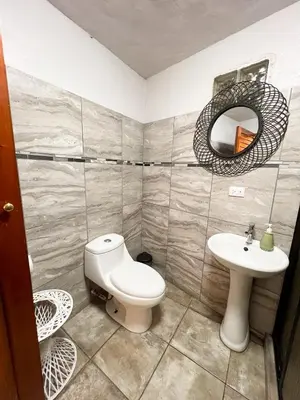 a bathroom with a toilet and a sink at Casa Guarumo in Manuel Antonio