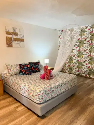 a bedroom with a bed with a canopy at Casa Guarumo in Manuel Antonio