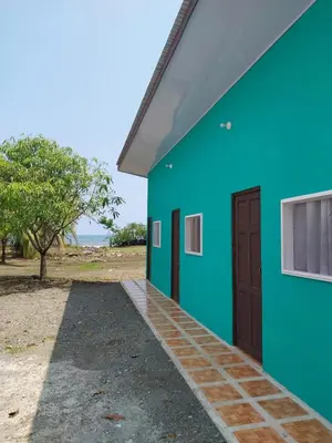 a blue and green building with a door at Apartamento de playa del Caribe in Moín