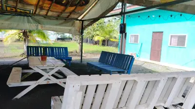 two blue chairs and a table under a tent at Apartamento de playa del Caribe in Moín