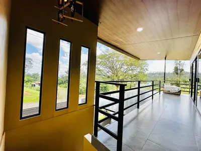 a room with a balcony with windows and a staircase at Villa Macua Private Pool and Bird Watching in Fortuna