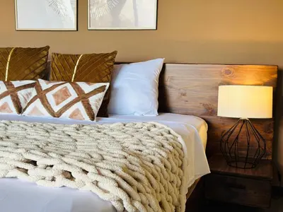 a bedroom with a bed with a blanket and a lamp at Villa Macua Private Pool and Bird Watching in Fortuna