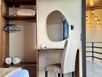 a room with a chair and a mirror at Villa Macua Private Pool and Bird Watching in Fortuna