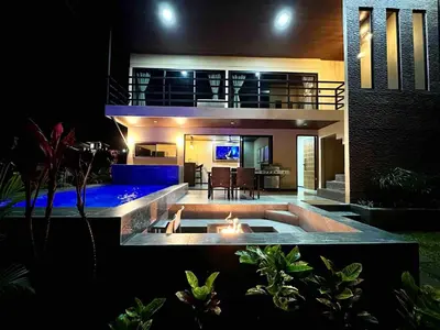 a house with a fire pit in the backyard at night at Villa Macua Private Pool and Bird Watching in Fortuna