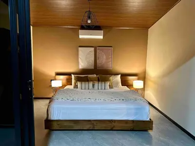 a bedroom with a large bed with two lamps at Villa Macua Private Pool and Bird Watching in Fortuna