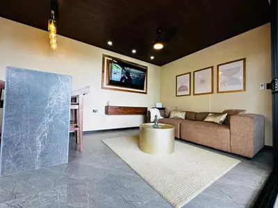 a living room with a couch and a tv at Villa Macua Private Pool and Bird Watching in Fortuna