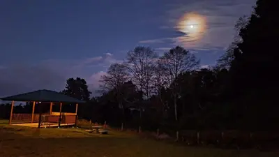a gazebo in a field at night with the moon at Cabaña de montaña in Cañón