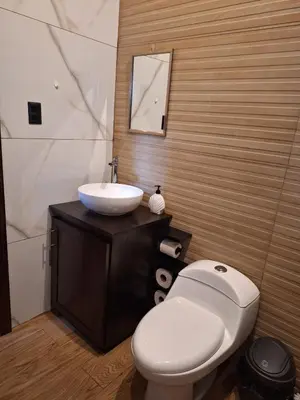 a bathroom with a white toilet and a sink at Cabaña de montaña in Cañón