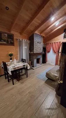 a dining room with a table and a fireplace at Cabaña de montaña in Cañón