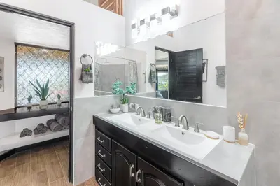 a bathroom with a sink and a mirror at Villa Sunrise - Incredible Ocean Views! in Ocotal