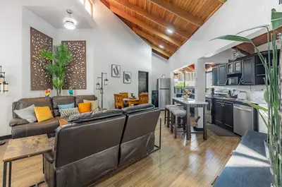 a living room with a couch and a table at Villa Sunrise - Incredible Ocean Views! in Ocotal