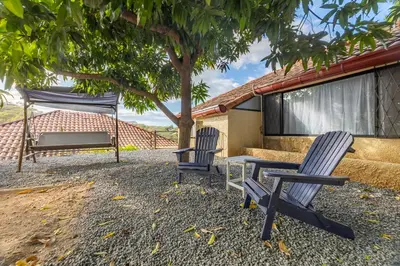 two chairs and a table and a hammock under a tree at Villa Sunrise - Incredible Ocean Views! in Ocotal