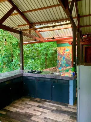an outdoor kitchen with a sink and a stove at Luna Escondida in Sarapiquí