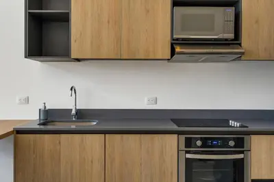 a kitchen with a sink and a microwave at 8-min Walk to Beach with Pool & Golf in Pochote