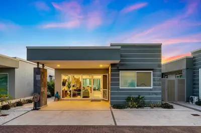 a house with a front door with a person standing outside at Casa Anbara Private Pool in Pochote