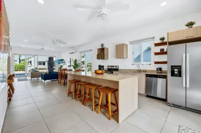a kitchen with a large island with bar stools at Casa Anbara Private Pool in Pochote