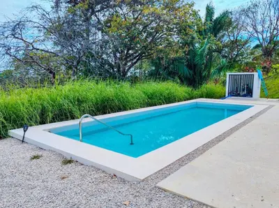 a small swimming pool in the middle of a yard at Casa Assaya in Nandayure