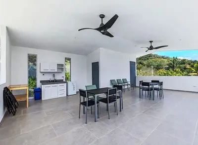 a kitchen and dining room with a table and chairs at Casa Assaya in Nandayure