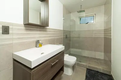 a bathroom with a white sink and a toilet at Private 3-Bedroom, 35-Bathroom Home With Amazing Ocean-Views In Playa Grande in Playa Grande