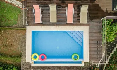 an outdoor swimming pool with chairs and a swimming pool at Private 3-Bedroom, 35-Bathroom Home With Amazing Ocean-Views In Playa Grande in Playa Grande