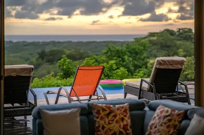 a living room with three chairs and a couch at Private 3-Bedroom, 35-Bathroom Home With Amazing Ocean-Views In Playa Grande in Playa Grande