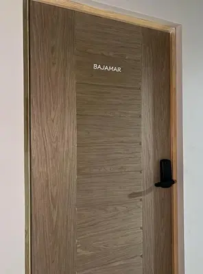 a wooden door with a sign on it at Bajamar, Puntarenas in Puntarenas