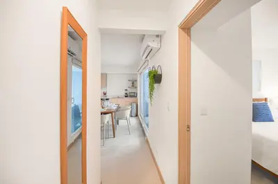 a hallway with a door leading to a bedroom at Upstay - New Condo Just Steps Away from the Beach in Jacó