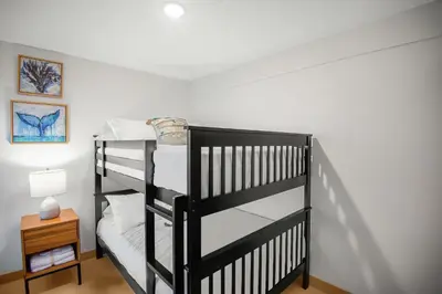 a black bunk bed in a room at Upstay - New Condo Just Steps Away from the Beach in Jacó