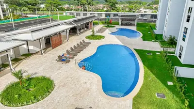an overhead view of a swimming pool on a building at Upstay - New Condo Just Steps Away from the Beach in Jacó