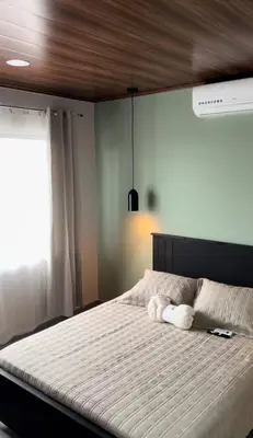 a bedroom with a large bed with a wooden ceiling at Cachorro, Puntarenas in Puntarenas