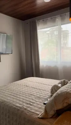 a bedroom with a bed and a window with a teddy bear at Cachorro, Puntarenas in Puntarenas