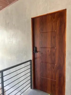 a wooden door in a room with a staircase at Cachorro, Puntarenas in Puntarenas
