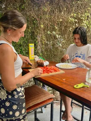 two women standing at a picnic table preparing food at The Backside House - Women Only - in Tamarindo