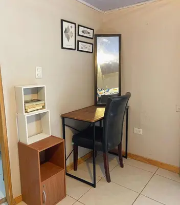 a desk with a chair and a mirror in a room at The Backside House - Women Only - in Tamarindo