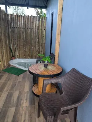 a patio with a table and chairs and a tub at Arenal Tiny Lodge #1 in San Francisco