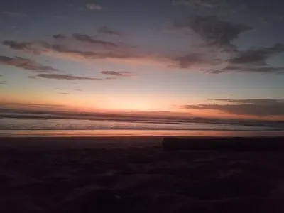 a sunset on the beach with the ocean in the background at Guanacaste Azul in Santa Cruz