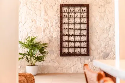 a stone wall with a mirror and a plant at Arbórea Villas in Chontales