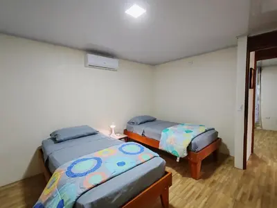 a room with two beds in a room at Villas Los Titos in La Fortuna in San Francisco