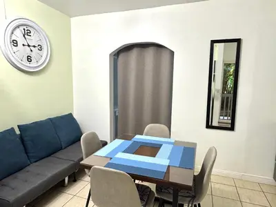 a living room with a table and a couch at A little bit of Paradise Ground Floor Studio in Coco