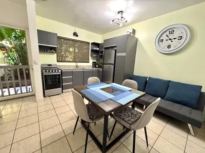 a kitchen and dining room with a table and a couch at A little bit of Paradise Ground Floor Studio in Coco