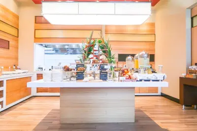 a kitchen with a counter with food on it at Hilton Garden Inn San Jose La Sabana, Costa Rica in San José