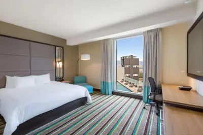 a hotel room with a bed and a large window at Hilton Garden Inn San Jose La Sabana, Costa Rica in San José