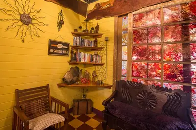a living room with a couch and a window at Casa Antigua Hotel in Alajuela City